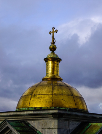Gold cross at top of Saint Isaac Cathedral in St. Petersburg, Russia.の写真素材