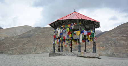 A shack with many praying flags on mountain in Ladakh, India. Ladakh is the highest plateau in the...