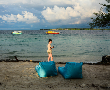 Lombok, Indonesia - Apr 17, 2016. A woman on beach at Gili Islands in Lombok, Indonesia. Lombok is known for beaches and surfing spots, particularly at Kuta and Banko Banko.のeditorial素材
