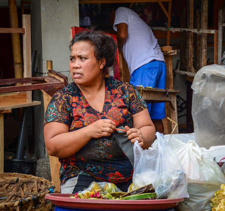 Bali, Indonesia - Apr 21, 2016. A vendor at the Central Market in Bali, Indonesia. Bali is a lush island paradise, famed for its art, culture, and recreation.のeditorial素材
