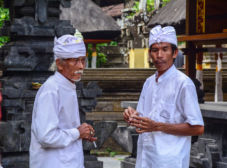 Bali, Indonesia - Apr 21, 2016. Priests standing at Elephant Cave Temple in Bali, Indonesia. Goa Gajah (Elephant Cave) is a Hindu temple located very close to Ubud in the hills of Bali.のeditorial素材