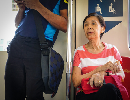 SINGAPORE - JUL 5, 2015. People sitting in MRT subway train in Singapore. The MRT is a rapid transit system forming the major component of the railway system in Singapore.のeditorial素材