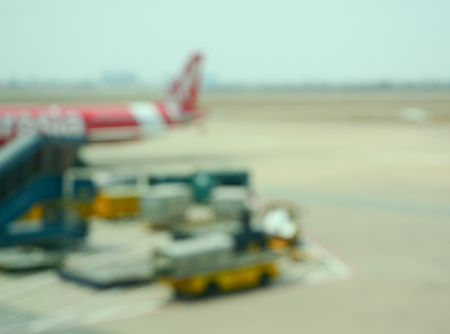 Blurred background, looking through terminal window to see airplane at airport.の写真素材