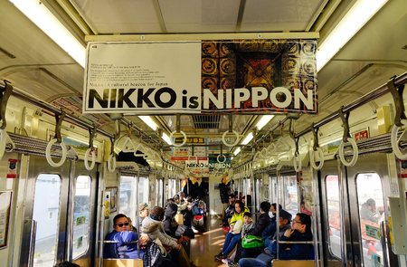 Tokyo, Japan - Jan 2, 2016. People sitting at a JR local train  in Tokyo, Japan. The railway system in Japan has a high reputation for punctuality and safety.のeditorial素材