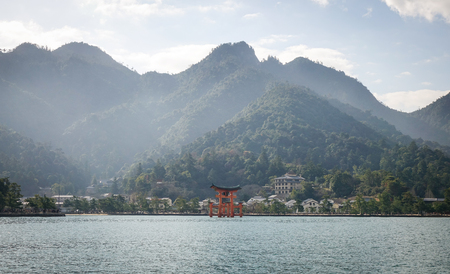 Mountain scenery with floating gate (Giant Torii) of Itsukushima Shrine in Hiroshima, Japan. The temple is a UNESCO World Heritage Site.のeditorial素材