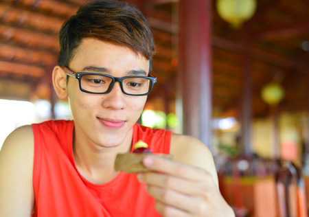 Asian man has breakfast at local restaurant in Vietnam.の写真素材
