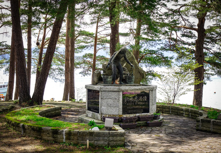 Tohoku, Japan - Mar 17, 2017. A monument at park of Lake Tazawa in Tohoku, Japan. The lake is Japan deepest at over 400m, and is surrounded by gently sloping hills.のeditorial素材