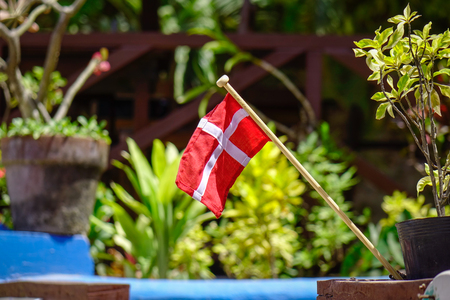 Small Denmark flag for decorations at a garden. Close up.の写真素材