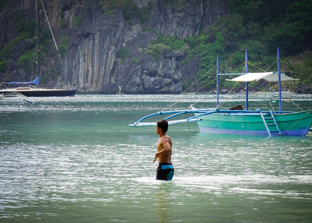 El Nido, Philippines - Apr 4, 2017. A man enjoying on sea in El Nido Town, Philippines. El Nido is known for its sand beaches, coral reefs, and as the gateway to small islands.のeditorial素材