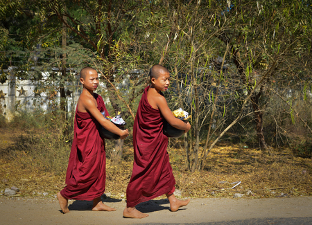Bagan, Myanmar - Feb 5, 2017. Buddhist monks walking for alms in Bagan, Myanmar. Bagan is one of the world greatest archeological sites, a sight to rival Machu Picchu.の写真素材