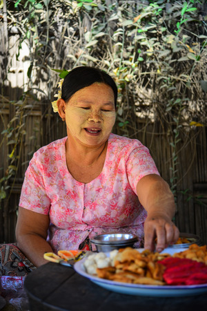 Yangon, Myanmar - Feb 5, 2017. A woman sells foods at business district in Yangon, Myanmar. Yangon is the country main centre for trade, industry and tourism.のeditorial素材