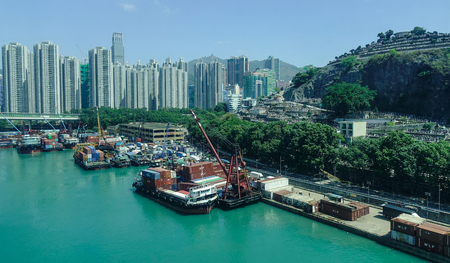 Hong Kong - Apr 1, 2017. A pier with many apartments at sunny day in Hong Kong. Hong Kong is an important hub in East Asia with global connections to many of the world cities.のeditorial素材