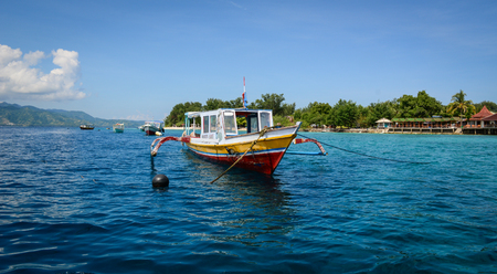 Bali, Indonesia - Apr 18, 2016. A wooden boat on the sea in Bali Island, Indonesia. Bali is part of the Coral Triangle, the area with the highest biodiversity of marine species.のeditorial素材