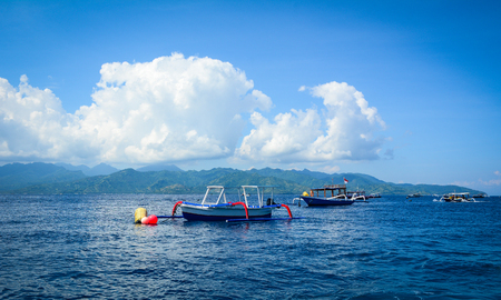 Bali, Indonesia - Apr 19, 2016. Tourist boats waiting on the sea in Bali, Indonesia. Bali is part of the Coral Triangle, the area with the highest biodiversity of marine species.のeditorial素材
