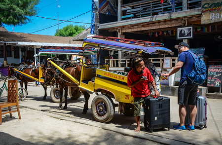 Lombok, Indonesia - Apr 19, 2016. Horse cart parking on street in Lombok Island, Indonesia. Lombok is an island next to Bali where the tourism is still in its infancy.のeditorial素材