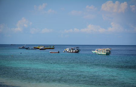 Bali, Indonesia - Apr 18, 2016. Tourist boats on the sea in Bali Island, Indonesia. Bali is part of the Coral Triangle, the area with the highest biodiversity of marine species.のeditorial素材