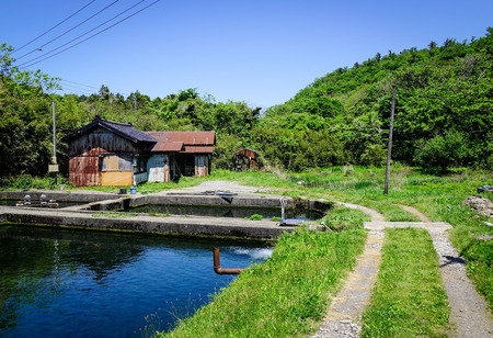 Countryside house with a lake in Akita, Japan. Akita is a large prefecture at the Sea of Japan coast in the northern Tohoku Region.の写真素材