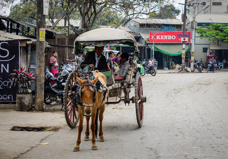 Bagan, Myanmar - Feb 25, 2016. Horse cart running on the rural road in Bagan, Myanmar. Bagan is an ancient city in central Myanmar (formerly Burma), southwest of Mandalay.のeditorial素材
