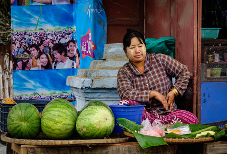 Mandalay, Myanmar - Feb 23, 2016. A woman selling fresh fruits at local market in Mandalay, Myanmar. Mandalay is the second largest city in Burma, and a former capital of Myanmar.のeditorial素材