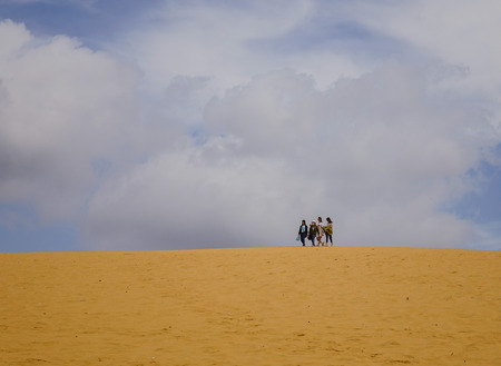 Mui Ne, Vietnam - Mar 26, 2017. People walking on the sand dunes in Mui Ne, Vietnam. Sand Dunes just outside of Mui Ne are one of Vietnam charming geological oddities.のeditorial素材