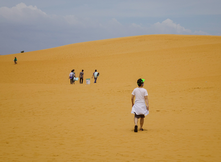 Mui Ne, Vietnam - Mar 26, 2017. People visit the sand dunes in Mui Ne, Vietnam. Sand Dunes just outside of Mui Ne are one of Vietnam charming geological oddities.の写真素材