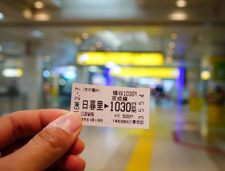 Tokyo, Japan - Dec 7, 2016. Hand holding a train ticket at the JR station in Tokyo, Japan. Railways are the most important means of passenger transportation in Japan.のeditorial素材