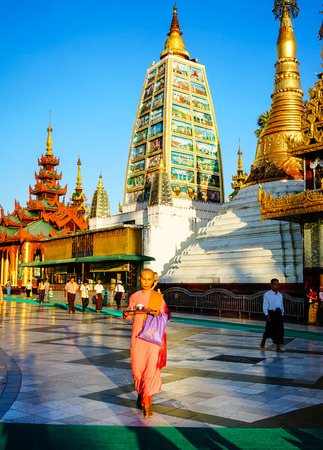 Yangon, Myanmar - Oct 16, 2015. Local people walking at Shwedagon Pagoda in Yangon, Myanmar. The Shwedagon Pagoda is one of the most famous pagodas in the world.のeditorial素材