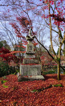 An ancient statue at the autumn garden in Kyoto, Japan. Kyoto served as Japan capital and the emperor residence from 794 until 1868.の写真素材