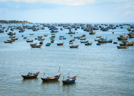 Traditional wooden boats on the sea at sunny day in Phan Thiet, Vietnam. Phan Thiet fish sauce has long become one of the famous brands for tourists.の写真素材