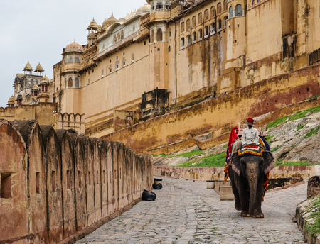 Jaipur, India - Jul 28, 2015. People riding elephant on the cobblestone path to Amber Fort in Jaipur, India. Elephant rides are popular tourist attraction in Amber Fort.のeditorial素材