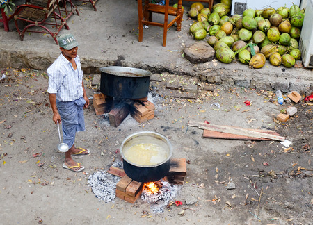 Yangon, Myanmar - Feb 25, 2016. A vendor cooking food at local market in Yangon, Myanmar. Yangon is the country main centre for trade, industry and tourism.のeditorial素材