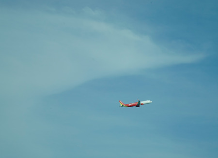 Saigon, Vietnam - Jan 2, 2017. Vietjet airplane flying in the sky in Saigon, Vietnam. Vietjet Air is the first low-cost airlines in Vietnam, launched at the end of 2009.のeditorial素材