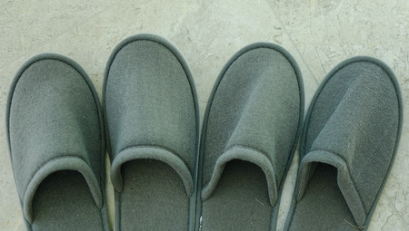 Close-up of bedroom slippers on floor at luxury hotel.のeditorial素材