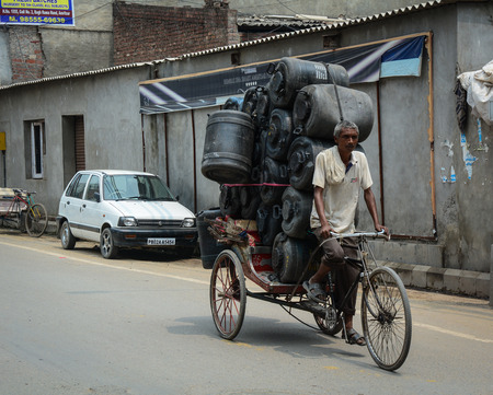 Amritsar, India - Jul 25, 2015. An Indian man riding rickshaw in Amritsar, India. Amritsar is a holy...
