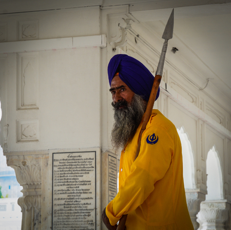 Amritsar, India - Jul 25, 2015. A Sikh guard standing at the Golden Temple in Amritsar, India....