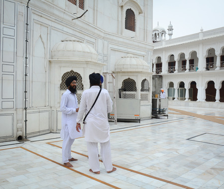 Amritsar, India - Jul 25, 2015. Sikh men standing at the Golden Temple in Amritsar, India. Golden temple is also known as Harmandir Sahib, a significant Sikh temple, which is located in Amritsar.のeditorial素材