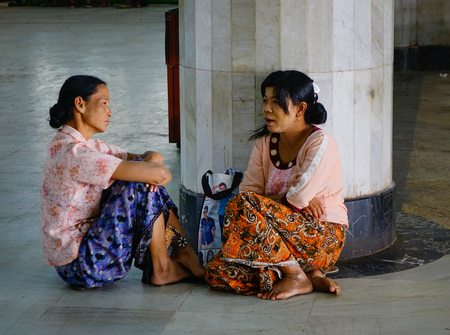 Mandalay, Myanmar - Feb 22, 2016. Women sitting and waiting at train station in Mandalay, Myanmar. Mandalay is the second-largest city and the last royal capital of Myanmar (Burma).のeditorial素材