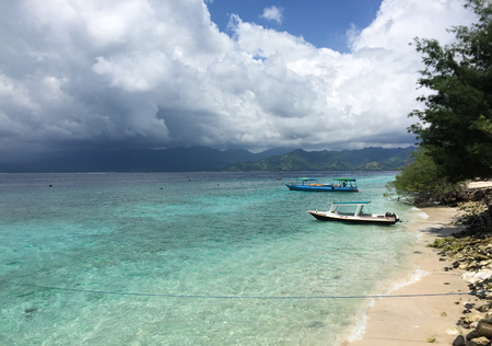 Lombok, Indonesia - Apr 17, 2016. Tourist boats on beach in Lombok Island, Indonesia. Lying to the east of Bali, Lombok is the quieter and less developed alternative to its more famous neighbour.のeditorial素材