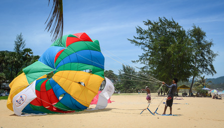 Phuket, Thailand - Jun 19, 2016. People playing parasailing in Phuket, Thailand. Phuket nestles in balmy Andaman Sea waters on Thailand Indian Ocean coastline.のeditorial素材