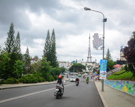 Dalat, Vietnam - Jul 5, 2016. People ride scooters on street at sunny day in Dalat Highlands, Vietnam. Da Lat is located 1,500 m above sea level on the Langbian Plateau.のeditorial素材