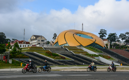 Dalat, Vietnam - Jul 5, 2016. People riding scooters near Lam Vien Square in Dalat, Vietnam. Dalat is located 1,500 m (4,900 ft) above sea level on the Langbian Plateau.