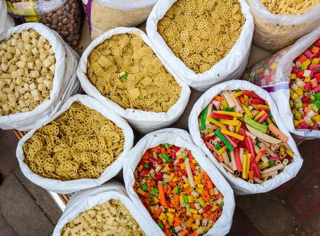 Selling dried noodles and foods at a spice market in Old Delhi, India.の写真素材