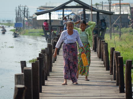 Inle, Myanmar - Feb 14, 2016. People walking on wooden bridge in Inle Lake, Myanmar. Inle is a freshwater lake located in the Nyaungshwe of Taunggyi District of Shan State.のeditorial素材
