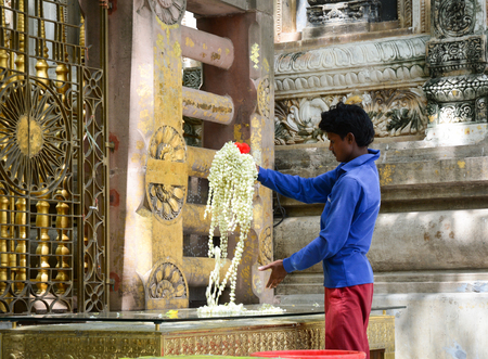 Bodh Gaya, India - Jul 9, 2015. A man working at Mahabodhi Temple Complex in Bodhgaya, India. The Mahabodhi Vihar, a UNESCO World Heritage Site, is a Buddhist temple.のeditorial素材
