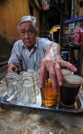 Hanoi, Vietnam - Sep 22, 2013. Street vendor at Old Quarter in Hanoi, Vietnam. The Old Quarter maintains most of the original street layout and some of the architecture of old Hanoi.のeditorial素材