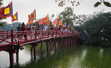 Hanoi, Vietnam - Sep 22, 2013. People walking on The Huc Bridge at sunny day in Hanoi city, Vietnam. The Huc Bridge is a beautiful construction located in the heart of Hoan Kiem Lake.のeditorial素材