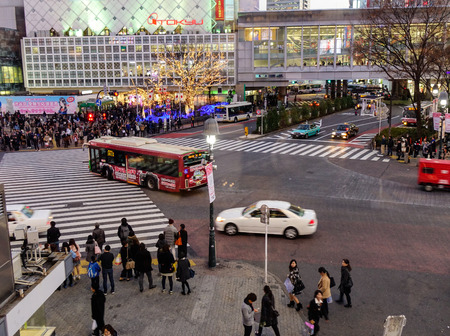 Tokyo, Japan - Jan 4, 2016. People and vehicles at Shibuya Crossing in Tokyo, Japan. Shibuya is a shopping and eating district popular with a lot of young Tokyoites.のeditorial素材