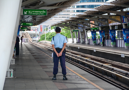 Bangkok, Thailand - Jun 15, 2016. A guard standing at BTS station in Bangkok, Thailand. Bangkok attractions and city life appeal to diverse groups of tourists.のeditorial素材