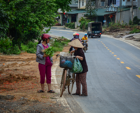 Mai Chau, Vietnam - May 25, 2016. People on mountain road in Mai Chau, Northern Vietnam. Mai Chau is a rural district of Hoa Binh Province in the Northwest region of Vietnam.のeditorial素材