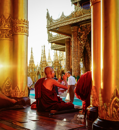 Yangon, Myanmar - Oct 16, 2015. Monks praying at Shwedagon Pagoda in Yangon, Myanmar. Shwedagon (Great Dagon) Pagoda is the most sacred Buddhist pagoda in Myanmar.のeditorial素材